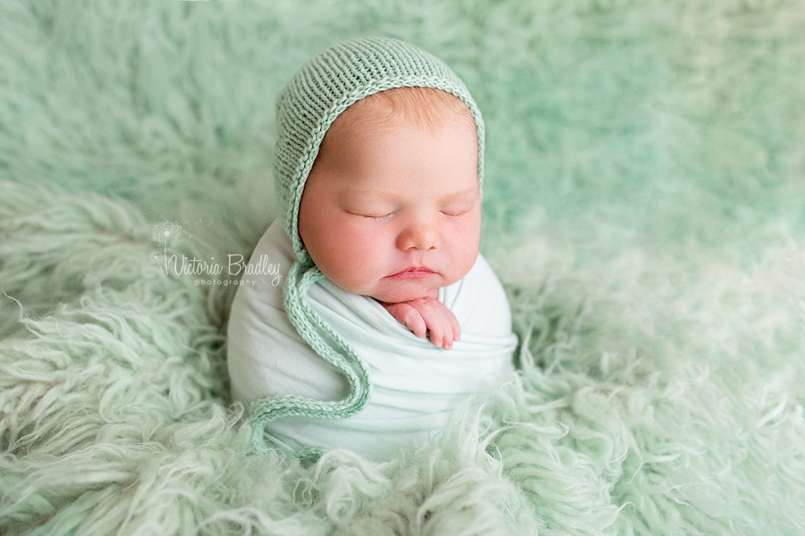 potato sack pose on pale green flokati