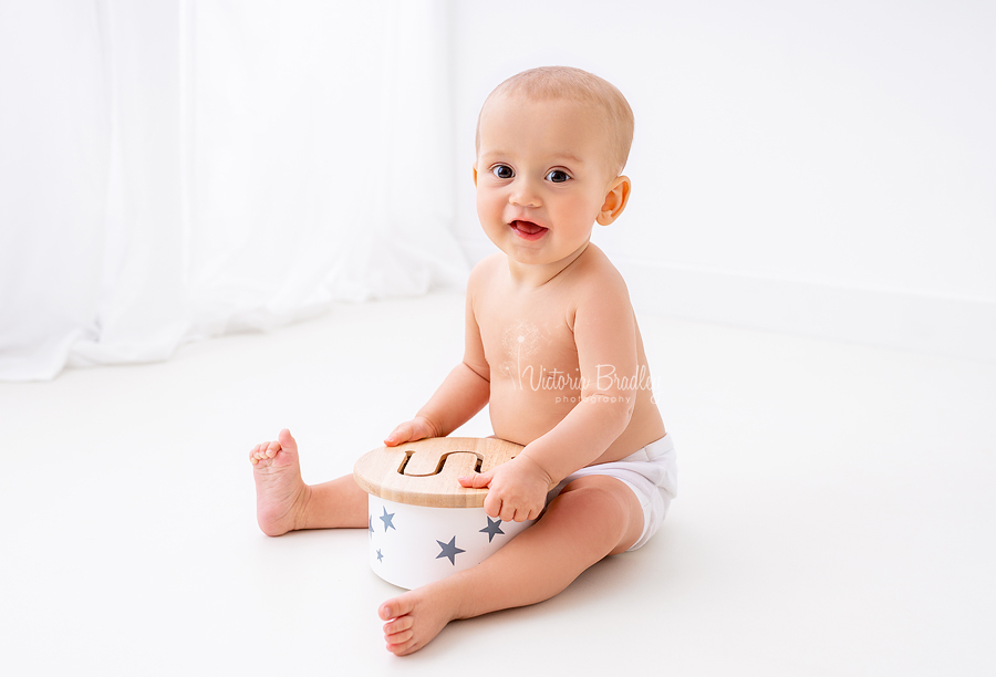 baby in diaper cover with drum