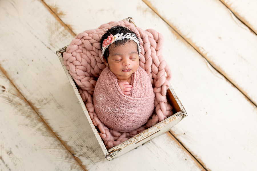 Baby A newborn wrapped in dusky pink